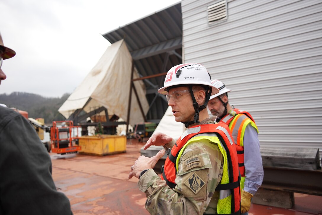 LANCASTER, Tenn. (Feb. 19, 2026) – Josh Munzek (left), project manager for American Bridge Company, briefs Col. Herlihy, commander of the Great Lakes and Ohio River Division, on the status of the spillway gate replacement project at Center Hill Dam Feb. 19, 2026. The discussion took place on a barge where new gates were being assembled and welded for future installation.