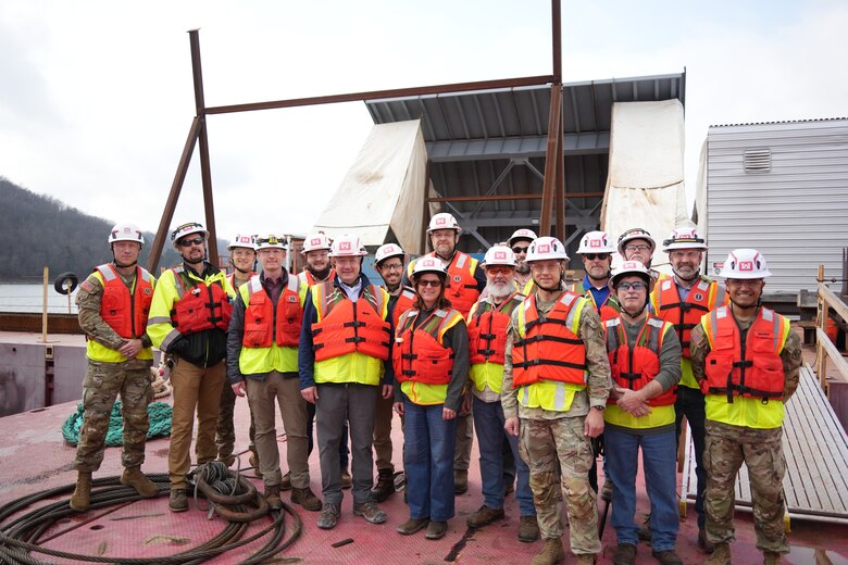 LANCASTER, Tenn. (Feb. 19, 2026) – Col. Herlihy, commander of the Great Lakes and Ohio River Division, poses for a group photo with U.S. Army Corps of Engineers Nashville District leaders, project managers, engineers, and specialists in front of newly assembled spillway gates at Center Hill Dam in Lancaster, Tennessee, Feb. 19, 2026. The team briefed the commander on the progress of the major gate replacement project during his tour of the facility.