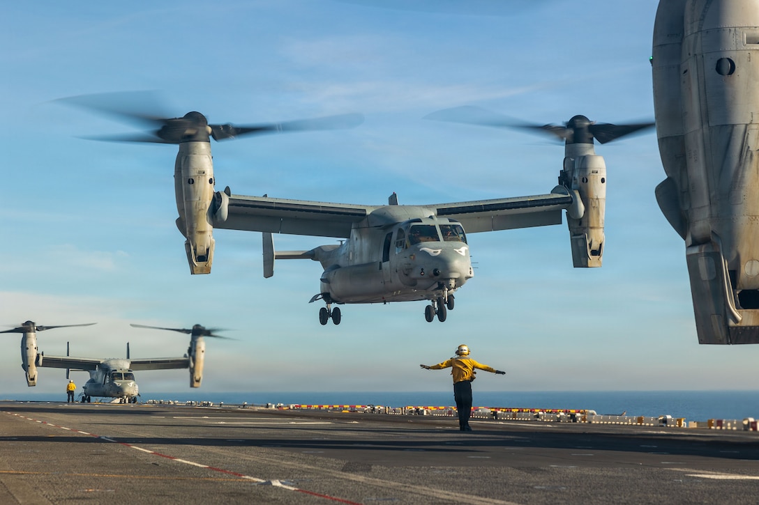 A U.S. Sailor assigned to Wasp-class amphibious assault ship USS Boxer (LHD 4) guides an MV-22B Osprey with Marine Medium Tiltrotor Squadron (VMM) 163 (Reinforced), 11th Marine Expeditionary Unit, during flight operations in the Pacific Ocean, Feb. 23, 2026. The 11th MEU is currently underway aboard the Boxer Amphibious Ready Group in the U.S. 3rd Fleet area of operations conducting integrated training that enhances lethality and warfighting readiness. (U.S. Marine Corps photo by Lance Cpl. Nicole Stuart)