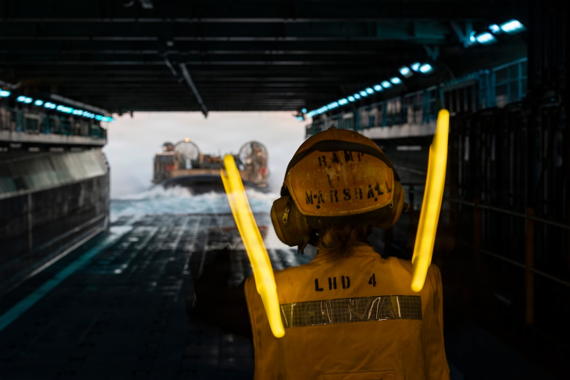 A U.S. Sailor assigned to Wasp-class amphibious assault ship USS Boxer (LHD 4), guides a landing craft, air cushion attached to Assault Craft Unit 5 during ship-to-shore operations in the Pacific Ocean, Feb. 23, 2026.