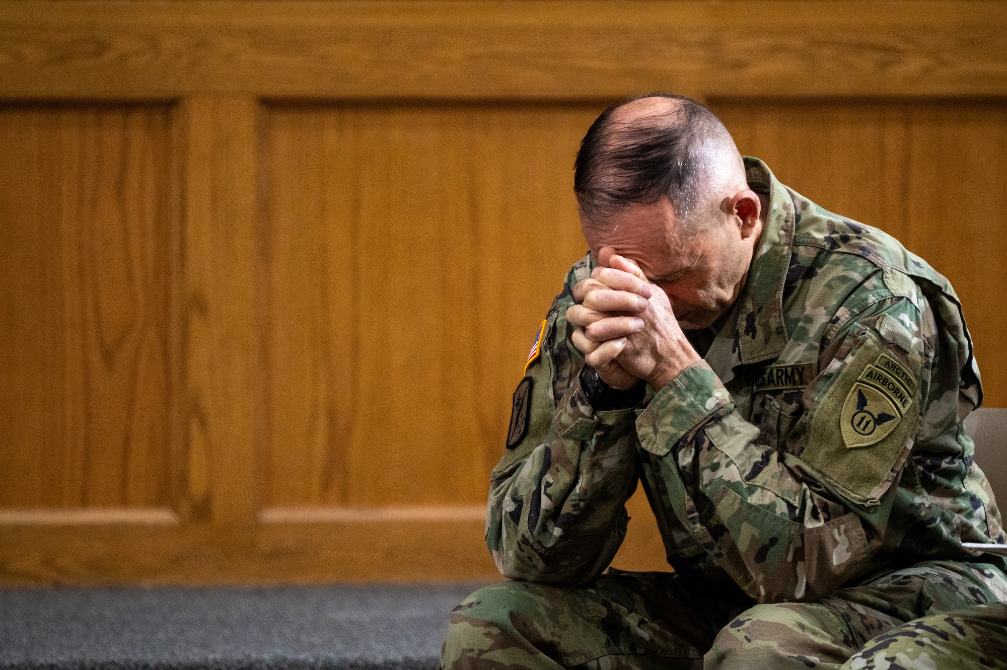U.S. Army Lt. Col. Kevin Daul, 673d Air Base Wing deputy installation chaplain, prays during a service honoring the Four Chaplains at the Arctic Warrior Chapel on Joint Base Elmendorf-Richardson, Alaska, Feb. 3, 2026. The legacy of the Four Chaplains remains a powerful source of inspiration for the religious support teams that help promote spiritual fitness throughout the service. (U.S. Air Force photo by Airman 1st Class Theodore Gowdy)