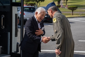 U.S. Air Force Brig. Gen. John Gallemore, right, 18th Wing commander, shakes hands with Lt. Gen. (ret.) Toshimichi Nagaiwa, Japan-America Air Force Goodwill Association tour leader, at Kadena Air Base, Japan, Feb. 18, 2026.