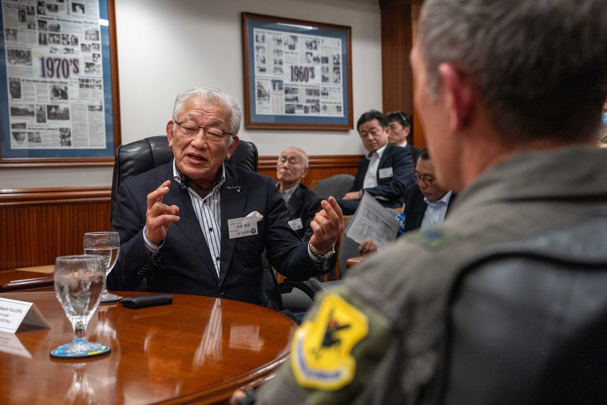 Japan Self Defense Force Lt. Gen. (ret.) Toshimichi Nagaiwa, Japan-America Air Force Goodwill Association tour leader, speaks to U.S. Air Force Brig. Gen. John Gallemore, 18th Wing commander, during JAAGA’s visit to Kadena Air Base, Japan, Feb. 18, 2026.