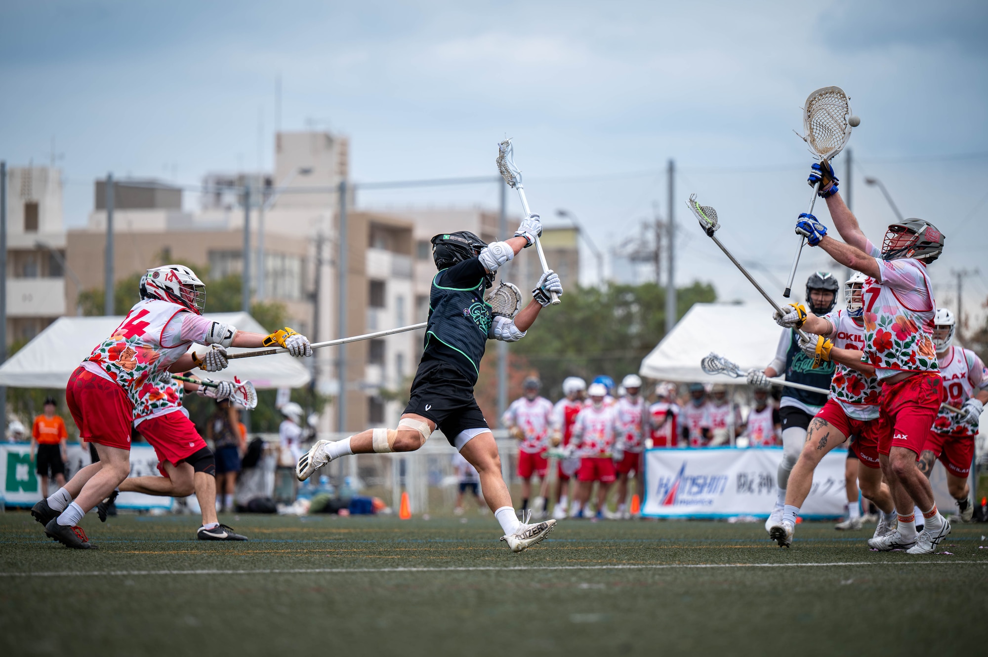 A Kamagaya Gators Lacrosse Club player passes the ball during a match against the Okinawa Lacrosse team at Shintoshin Park, Japan, Feb. 20, 2026. Engagement through sports support readiness, strengthens relationships and reinforces our commitment to enduring partnerships. (U.S. Air Force photo by Airman 1st Class Nathaniel Jackson)
