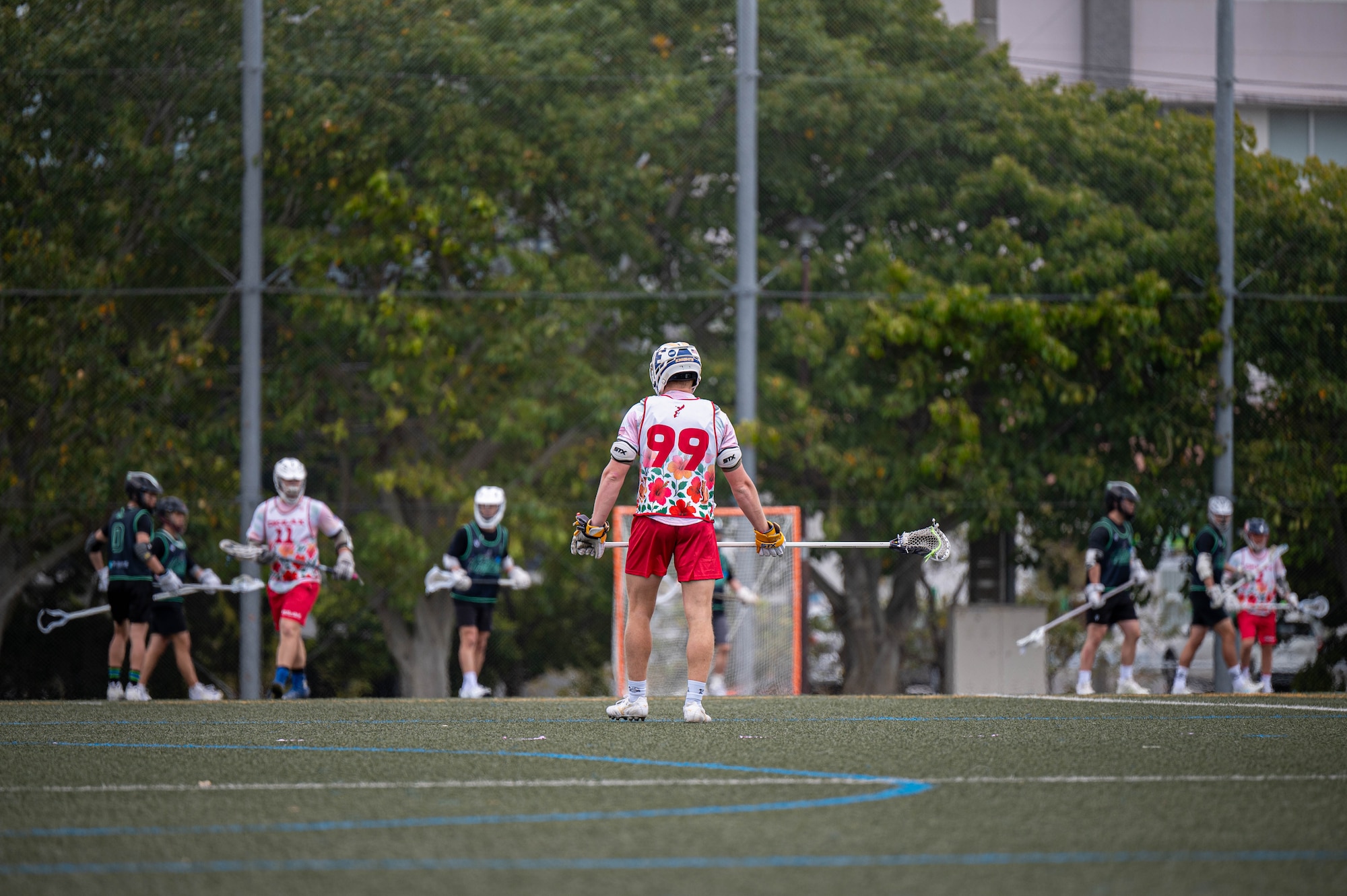 An Okinawa Lacrosse team player looks downfield during a match against the Kamagaya Gators Lacrosse Club at Shintoshin Park, Japan, Feb. 20, 2026. The OKI LAX team is composed of U.S. service members and civilians stationed across Okinawa and the local community, representing a mix of units, backgrounds and experience levels. (U.S. Air Force photo by Airman 1st Class Nathaniel Jackson)