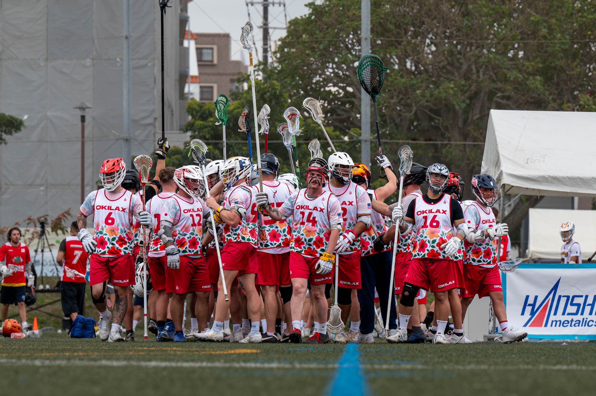 The Okinawa Lacrosse team breaks huddle during a match against the Kamagaya Gators Lacrosse Club at Shintoshin Park, Japan, Feb. 20, 2026. The OKI LAX team is composed of U.S. service members and civilians stationed across Okinawa and the local community, representing a mix of units, backgrounds and experience levels. (U.S. Air Force photo by Airman 1st Class Nathaniel Jackson)