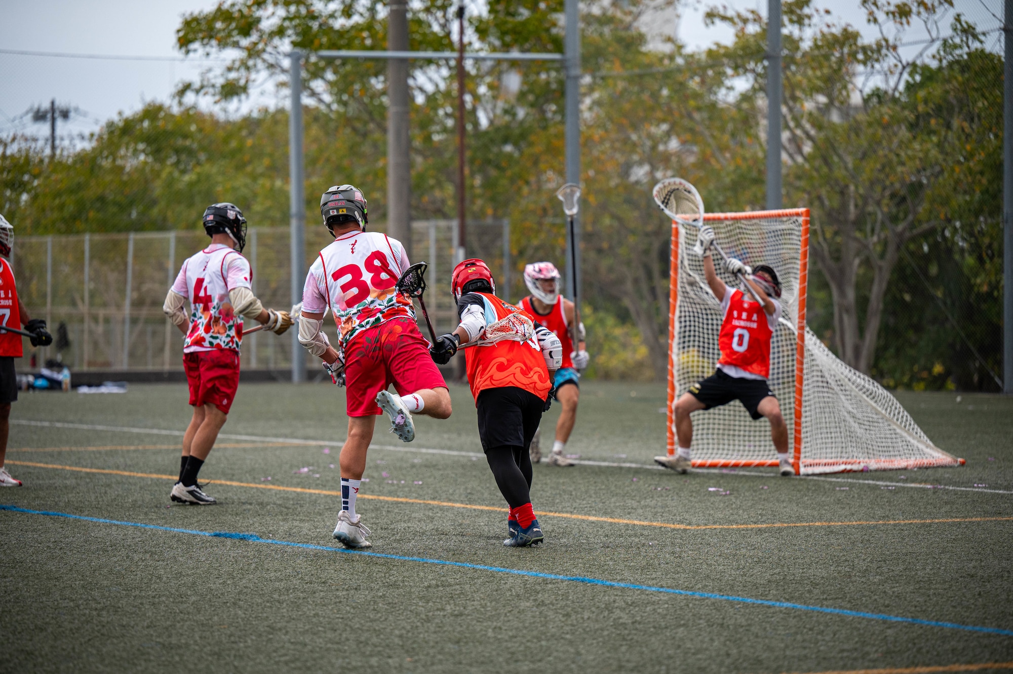 An Okinawa Lacrosse team player takes a shot during a match against the South East Asia Alliance Lacrosse Club at Shintoshin Park, Japan, Feb. 20, 2026. SEA Alliance Lacrosse Club is a combination of over 11 South East Asian countries that came together for the Lacrosse Okinawa Open 2026. (U.S. Air Force photo by Airman 1st Class Nathaniel Jackson)