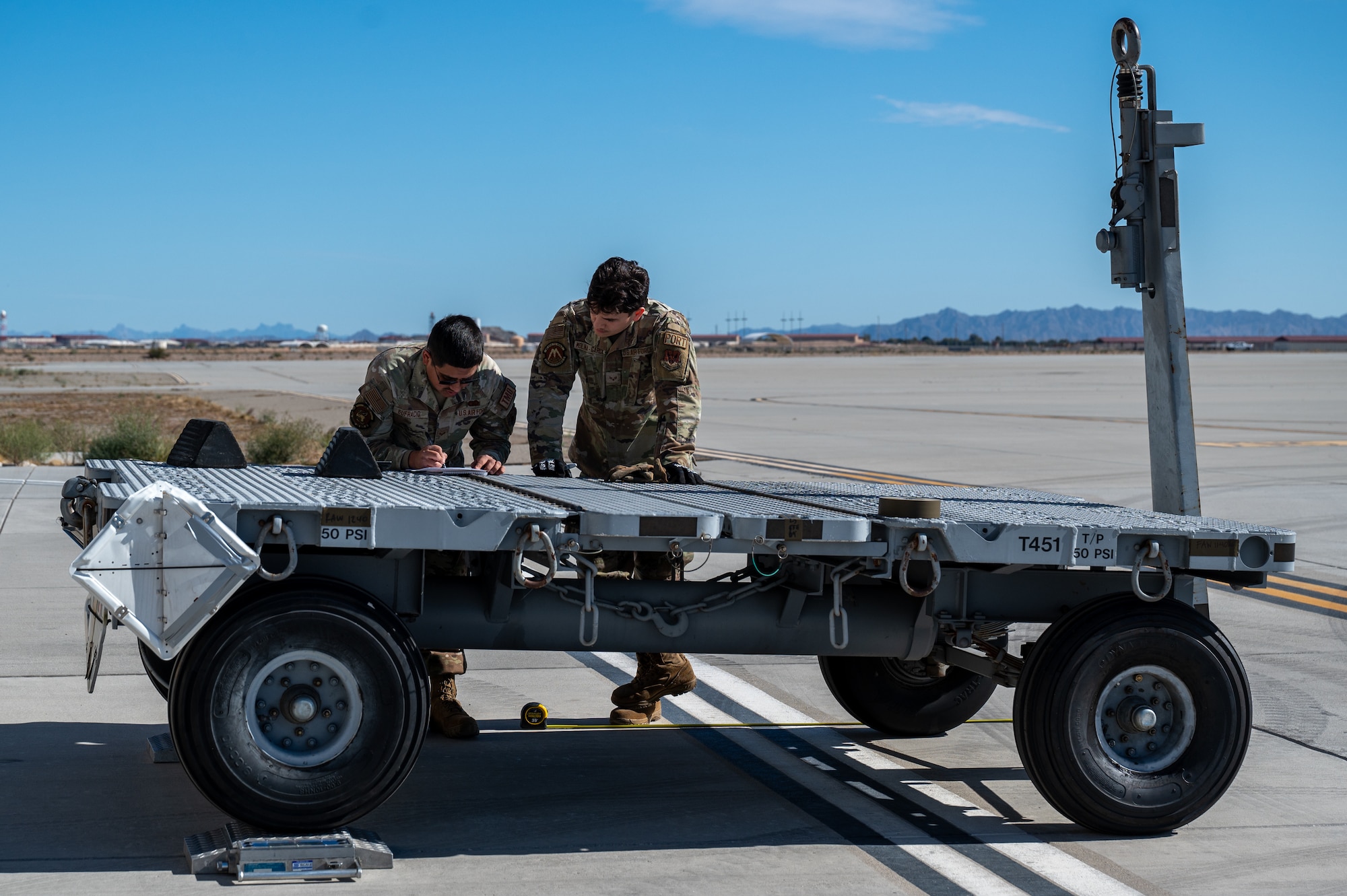 U.S. Air Force Senior Airman Christopher Eufracio, 21st Combat Air Base Squadron outbound cargo technician, and Senior Airman Oriol Molina-Garcia, 325th Logistics Readiness Squadron air transportation function journeyman, weigh equipment during exercise Bamboo Eagle 26-1.