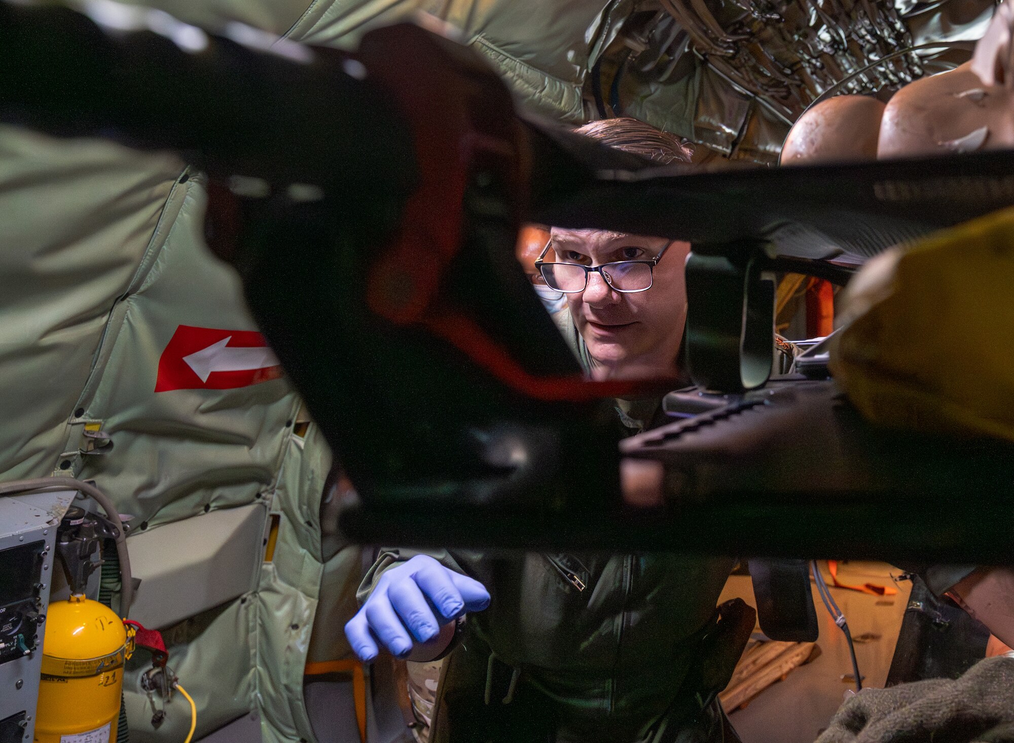 U.S. Air Force Maj. Raymond Kelly, 18th Aeromedical Evacuation Squadron flight nurse, treats a simulated patient aboard a KC-135 Stratotanker assigned to the 909th Air Refueling Squadron at Kadena Air Base, Japan, Feb. 17, 2026.