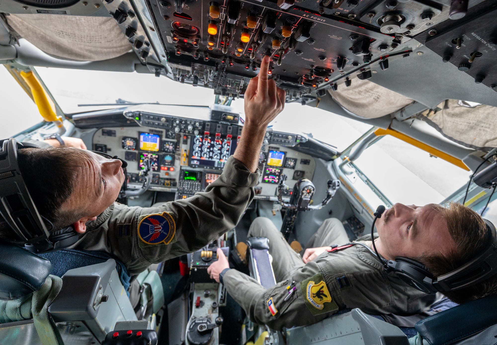 U.S. Air Force Capt. Walker Landry, left, and Capt. Kyler Wedgeworth, 909th Air Refueling Squadron KC-135 Stratotanker pilots, perform preflight checks before takeoff from Kadena Air Base, Japan, Feb. 17, 2026.