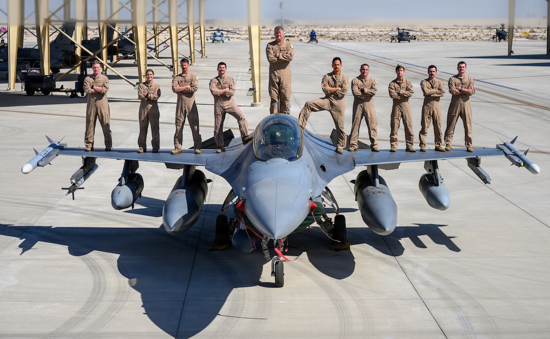 U.S. Air Force F-16 fighter pilots assigned to the 555th Expeditionary Fighter Squadron, pose for a group photo during exercise Spears of Victory at a base in the Middle East, Feb. 5, 2026. The Royal Saudi Air Force–led multinational training event brought together 10 nations to refine joint air operations and enhance interoperability across the coalition. (U.S. Air Force photo by Senior Airman Tyler A. P. Moody)