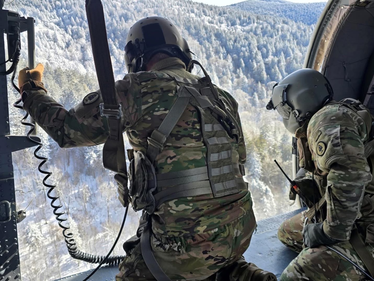 Sgt. Christopher Burke, a Black Hawk crew chief, and Master Sgt. Tracy Banta, a flight paramedic with the Tennessee Army National Guard, begin hoisting an injured hiker with severe cold weather injuries into a hovering UH-60 Black Hawk helicopter in the Great Smoky Mountains National Park, Feb. 24, 2026.