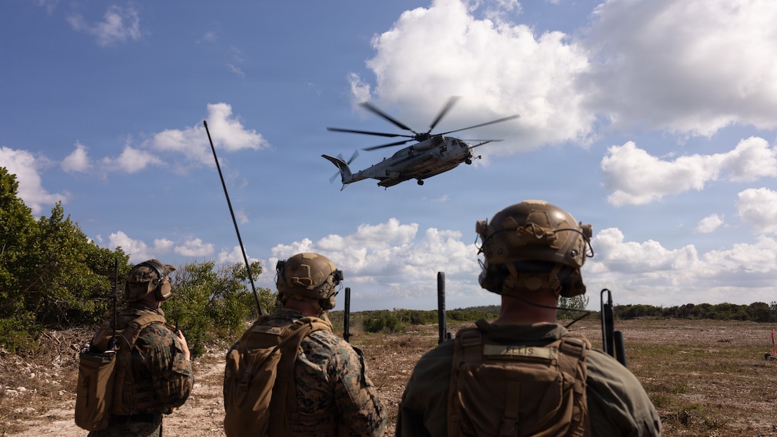 U.S. Marines with Marine Wing Support Squadron (MWSS) 271, Marine Air Control Group 28, 2nd Marine Aircraft Wing, observe a CH-53E Super Stallion with Marine Heavy Helicopter Squadron (HMH) 464, Marine Aircraft Group 29, 2nd MAW, land at the U.S. Navy’s Atlantic Undersea Test and Evaluation Center, Andros Island, The Bahamas, Feb. 16, 2026. MAG-29 Distributed Aviation Operations Exercise is a multi-week exercise designed to distribute command and control of aviation forces, pushing authorities to the lowest levels while keeping forces moving between airfields and air sites. MAG-29 DAO Exercise is scheduled to take place across the southeastern U.S. and the Caribbean, including North Carolina, South Carolina, Georgia, Florida, and The Bahamas.  (U.S. Marine Corps photo by Cpl. Anakin Smith)