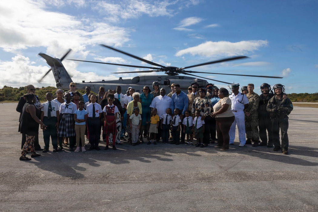 U.S. Ambassador Herschel Walker, from Georgia, and U.S. service members, deliver school supplies during Marine Aircraft Group 29's Distributed Aviation Operations Exercise at the U.S. Navy’s Atlantic Undersea Test and Evaluation Center, Andros Island, The Bahamas, Feb 18, 2026. MAG-29 DAO Exercise is a multi-week exercise designed to distribute command and control of aviation forces, pushing authorities to the lowest levels while keeping forces moving between airfields and air sites. MAG-29 DAO Exercise is scheduled to take place across the southeastern U.S. and the Caribbean, including North Carolina, South Carolina, Georgia, Florida, and The Bahamas. (U.S. Marine Corps photo by Lance Cpl. Bryan Giraldo) (U.S. Marine Corps photo by Lance Cpl. Bryan Giraldo)