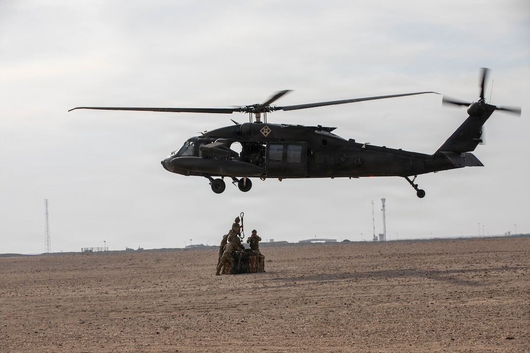 Soldiers assigned to U.S. Army Central conduct UH-60 Blackhawk sling-load training during a Pathfinder School field training exercise in the U.S. Central Command area of responsibility, Jan. 27, 2026. Pathfinder School trains Soldiers on aircraft orientation and helicopter landing zone operations, close combat assault, ground-to-air communication procedures, and sling-load operations. (U.S. Army photo by Capt. Bernard Jenkins)