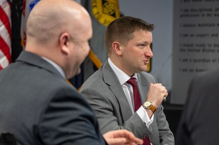 Jules W. Hurst III, senior official performing the duties of the Under Secretary of War (Comptroller) and chief financial officer, center, makes remarks as Art Miller, Deputy Comptroller for OUSW(C) Budget and Appropriations Affairs, smiles during a meeting with the U.S. Army Financial Management Command at the Maj. Gen. Emmett J. Bean Federal Center in Indianapolis Feb. 23, 2026. During the meeting, USAFMCOM provided a high-level overview of the two-star command’s mission support to the U.S. Army Materiel Command as well as its direct support to ASA (FM&C), outlining enterprise-level capabilities and authorities across the Army financial management portfolio, including Reserve Component integration. (U.S. Army photo by Mark R. W. Orders-Woempner)