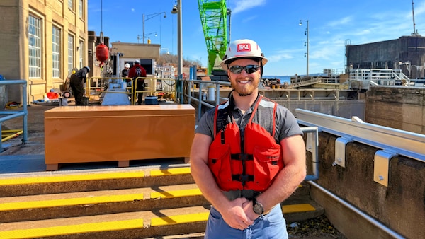 Mechanical Engineer Paul McDonald poses Feb. 24, 2026, at the Wilson Auxiliary Lock on the Tennessee River in Florence, Alabama, where he is working with a team to replace the critical hydraulic cylinders and the complex web of piping, pins, and A-frame assemblies that power the lock's massive filling and emptying valves to keep the navigation lock ship shape. (USACE Photo by Cayce Grall)