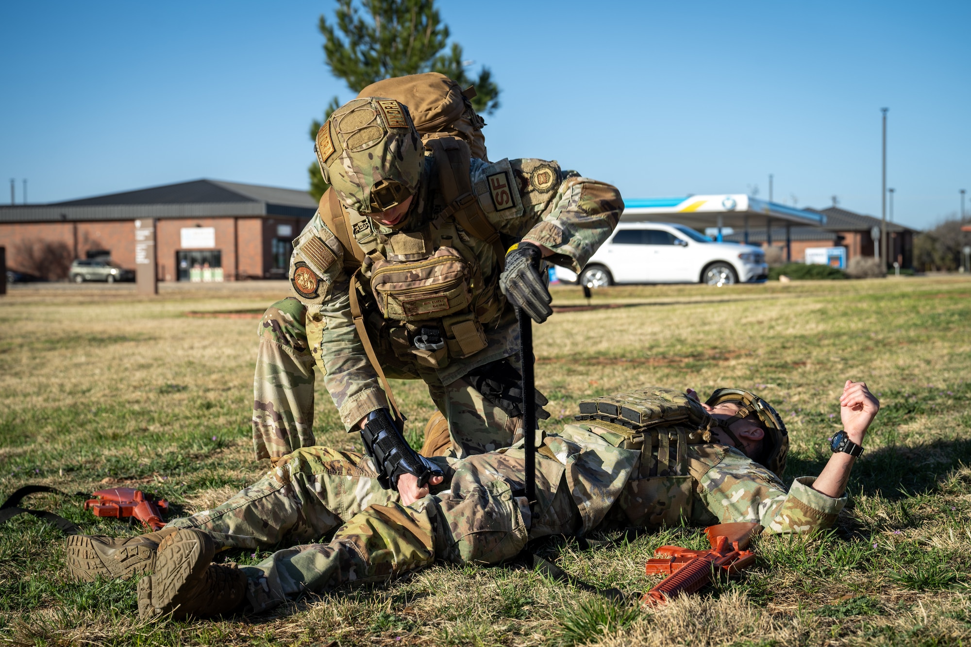 U.S. Air Force Airman Joshua Coffey, 21st Combat Air Base Squadron security forces patrolman, applies a tourniquet to Staff Sgt. Alan Ramsey, 21st CABS security forces patrolman, during exercise Bamboo Eagle 26-1 at Dyess Air Force Base, Texas, Feb. 19, 2026. Airmen refined their Tactical Combat Casualty Care skills during BE 26-1, certifying their ability to perform various tasks in austere locations. (U.S. Air Force photo by Airman 1st Class Adrien Tran)