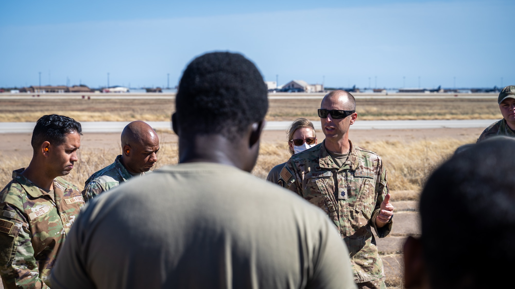 U.S. Air Force Lt. Col. Nathaniel White, 21st Combat Air Base Squadron commander, speaks to 21st CABS Airmen after landing zone operations training during exercise Bamboo Eagle 26-1 at Dyess Air Force Base, Texas, Feb. 18, 2026. These training operations reinforced the 21st CABS’s decision-making skills and adaptability, mirroring real-world mission demands. (U.S. Air Force photo by Airman 1st Class Adrien Tran)