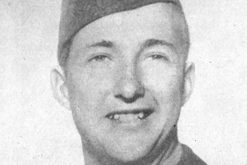 A man wearing a cap smiles for a photo.