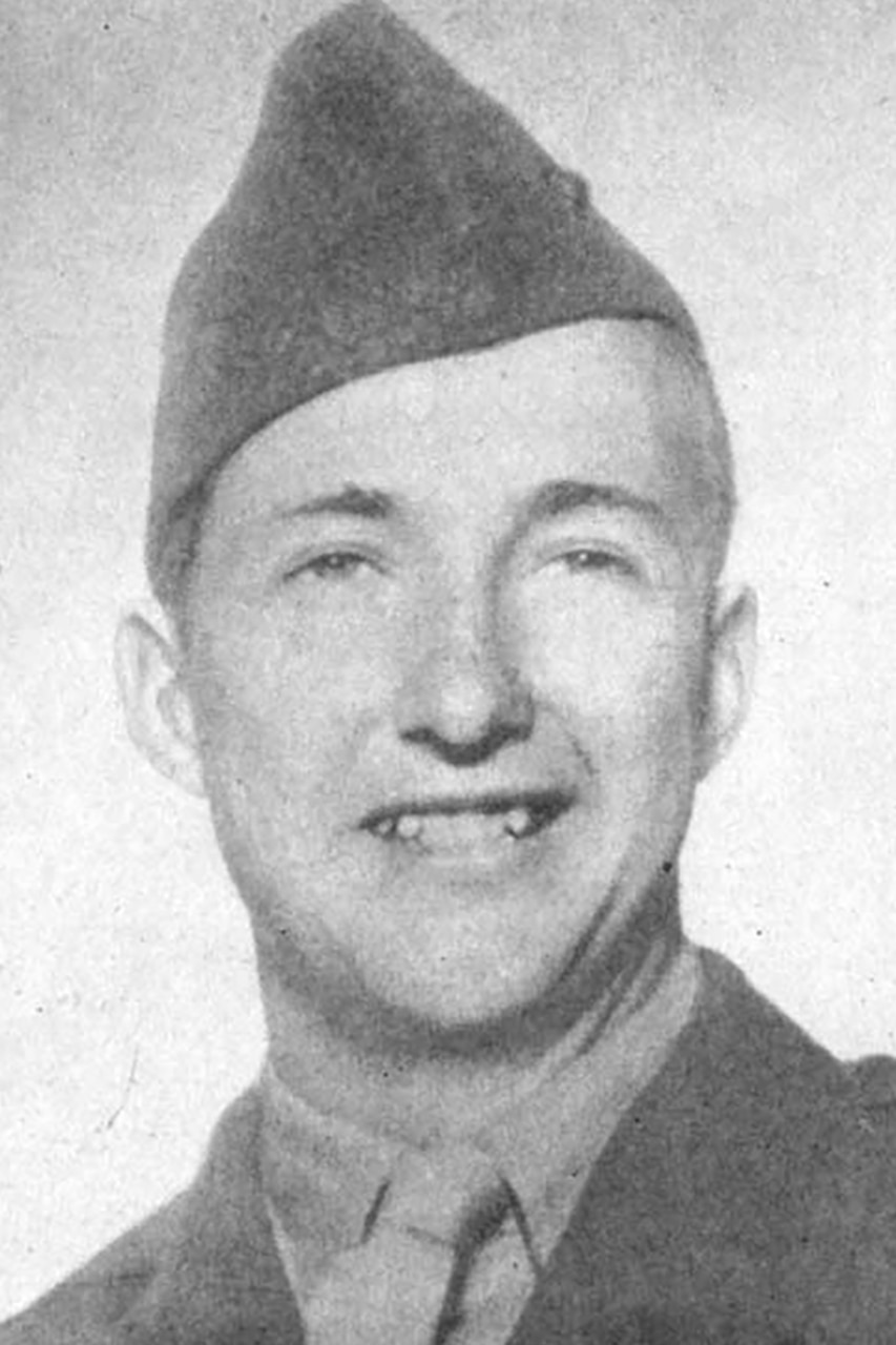 A man wearing a cap smiles for a photo.