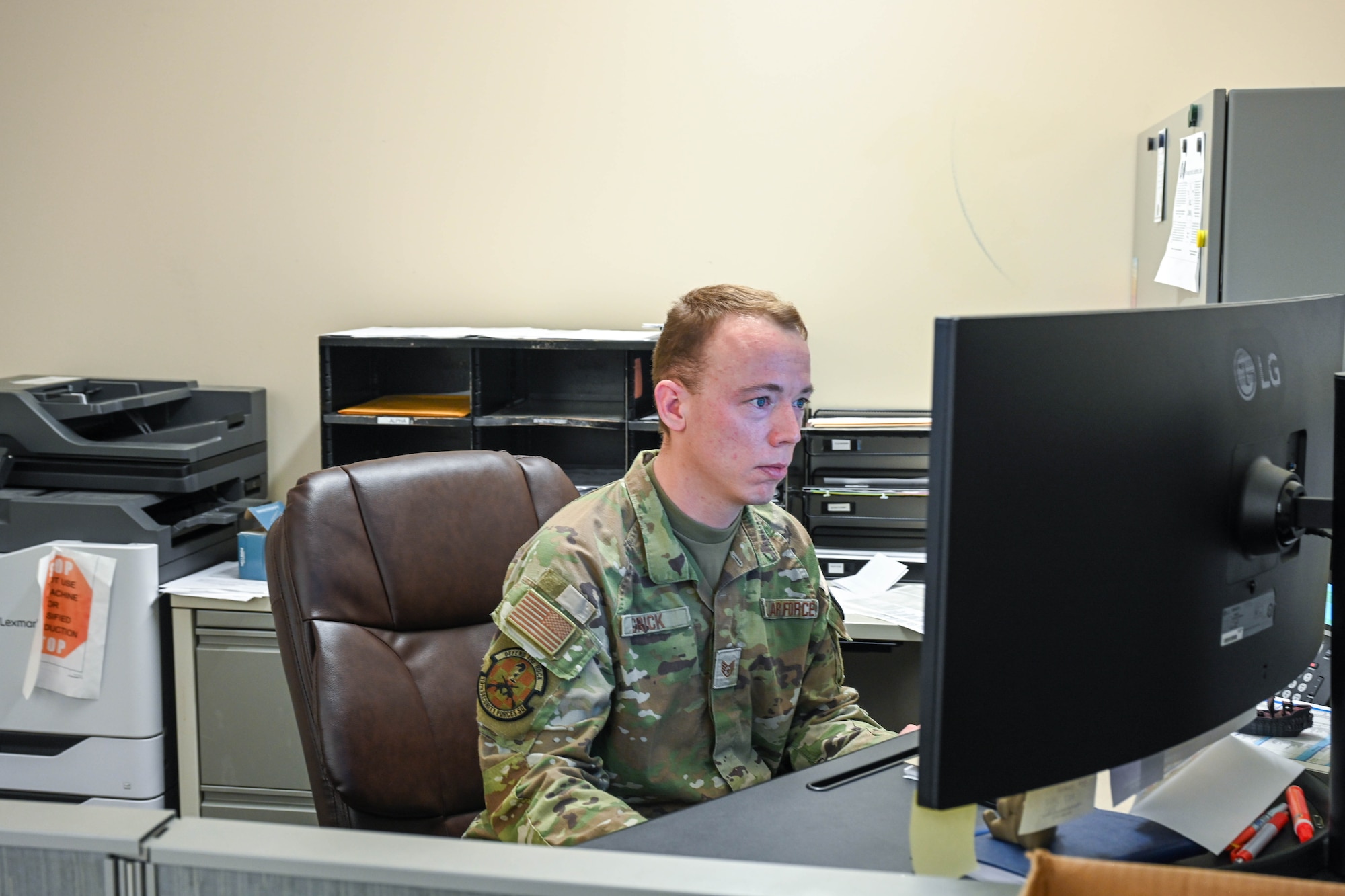 Man works on computer.