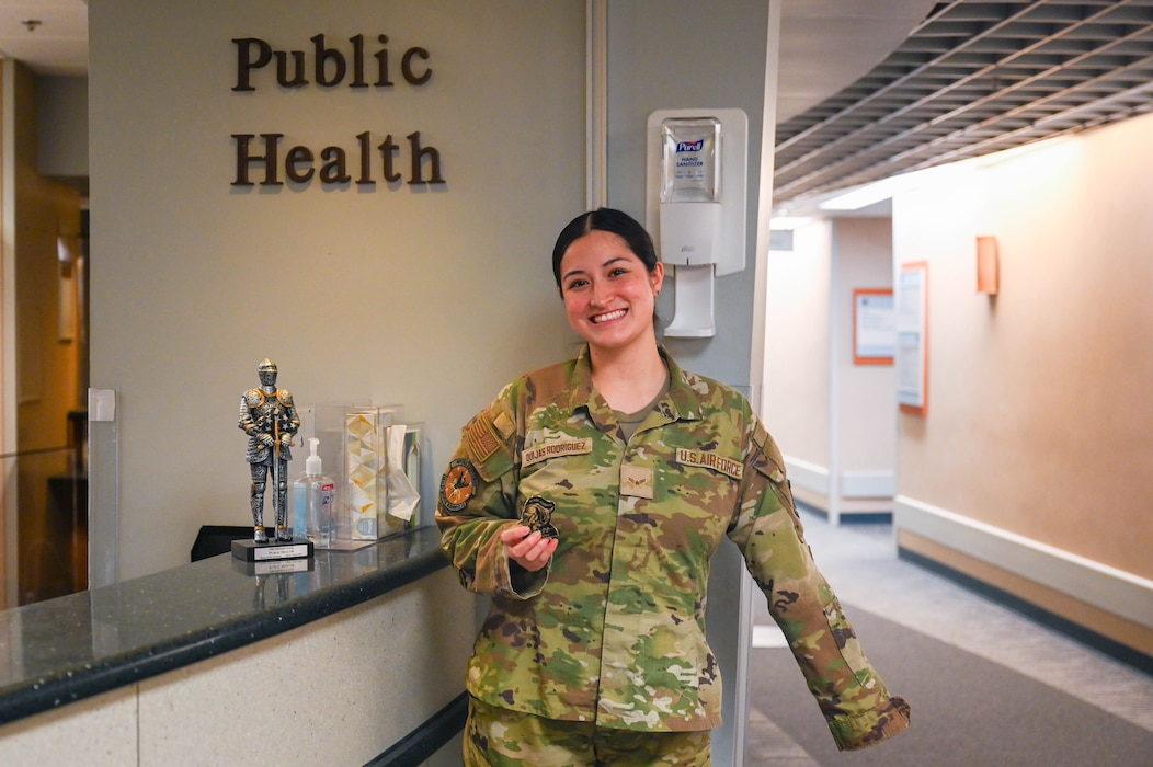 Woman poses in front of public health.