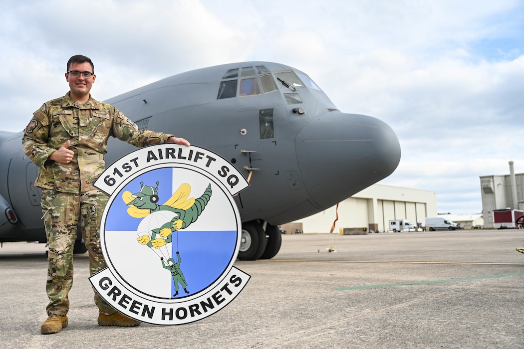 Man poses in front of a plane.