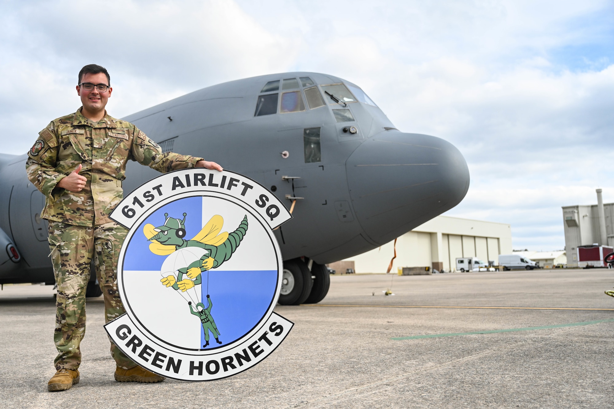 Man poses in front of a plane.