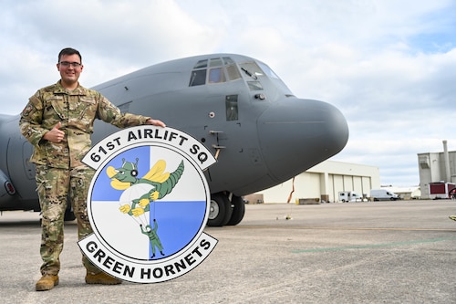 Man poses in front of a plane.