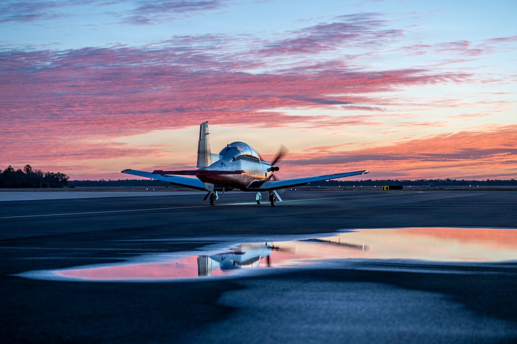 A U.S. Navy T-6B Texan II taxies down a runway at Avon Park Air Force Range, Florida, Jan. 27, 2026. 23 T-6B Texan II, 46 instructors and 86 students traveled to Avon Park AFR for joint primary aviation training (U.S. Air Force photo by Senior Airman Leonid Soubbotine)