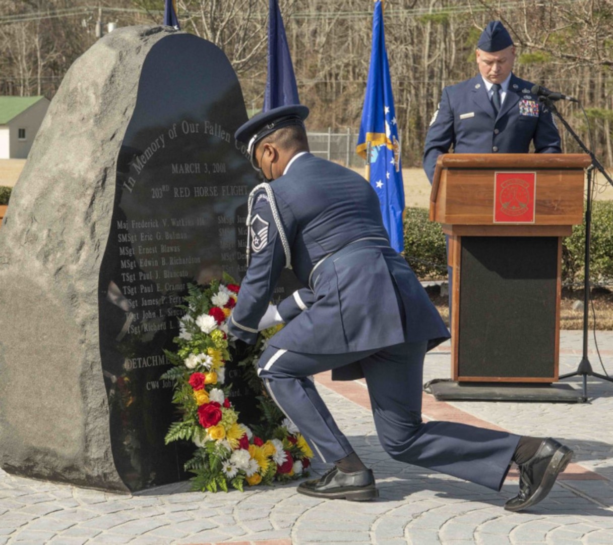 A Virginia Air National Guard Airman lays a wreath at the 203rd RED HORSE crash memorial at the State Military Reservation in Virginia Beach, Virginia, on the 20th anniversary of the tragic incident.