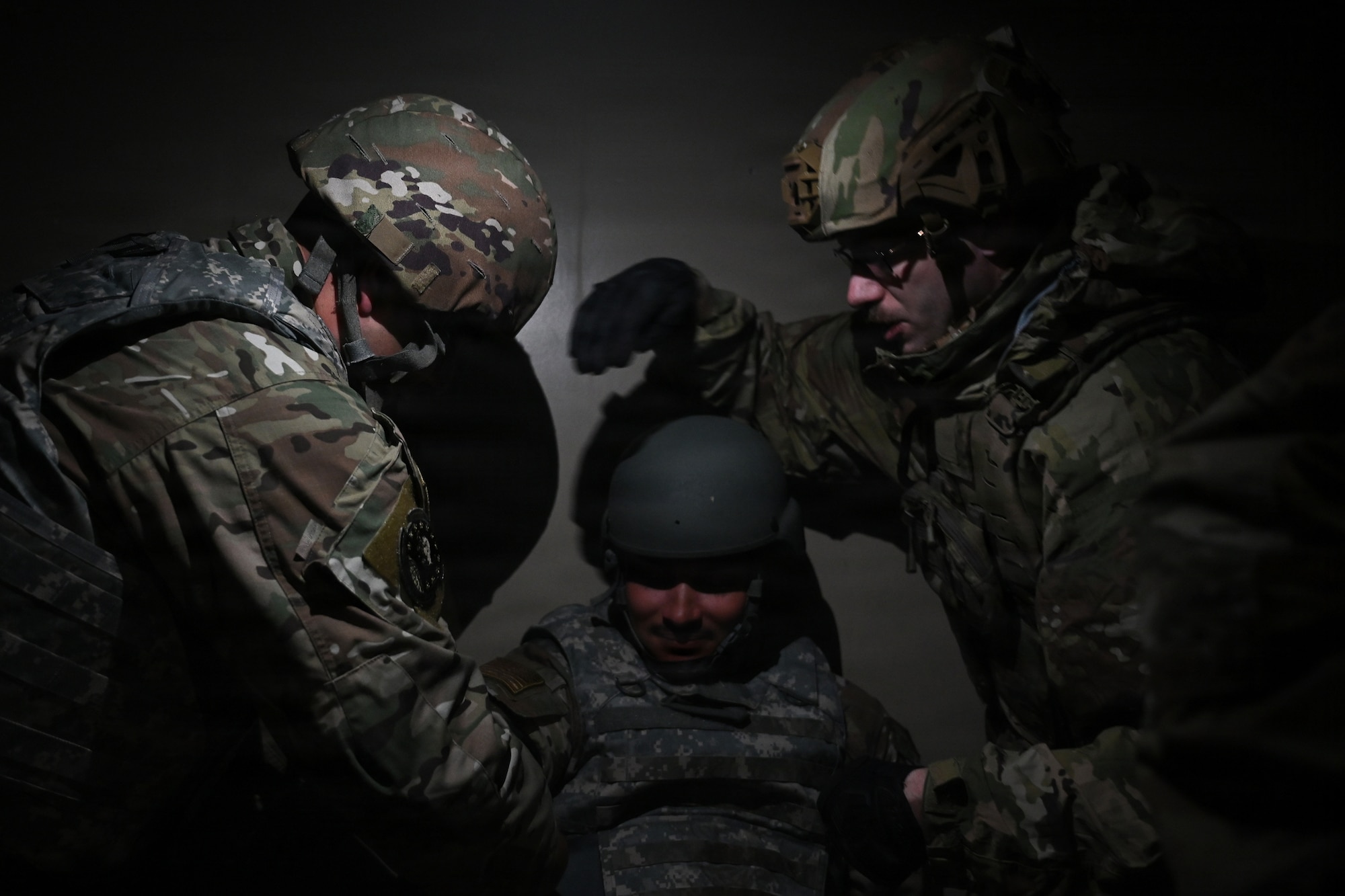 up photo of air force Airmen providing tactical combat casualty care to a simulated victim