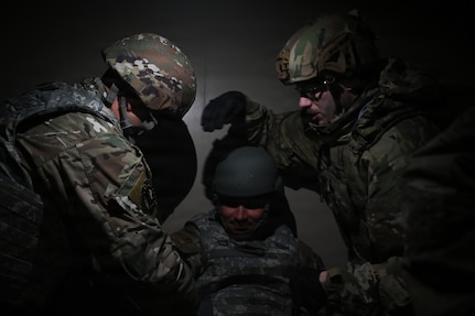 up photo of air force Airmen providing tactical combat casualty care to a simulated victim