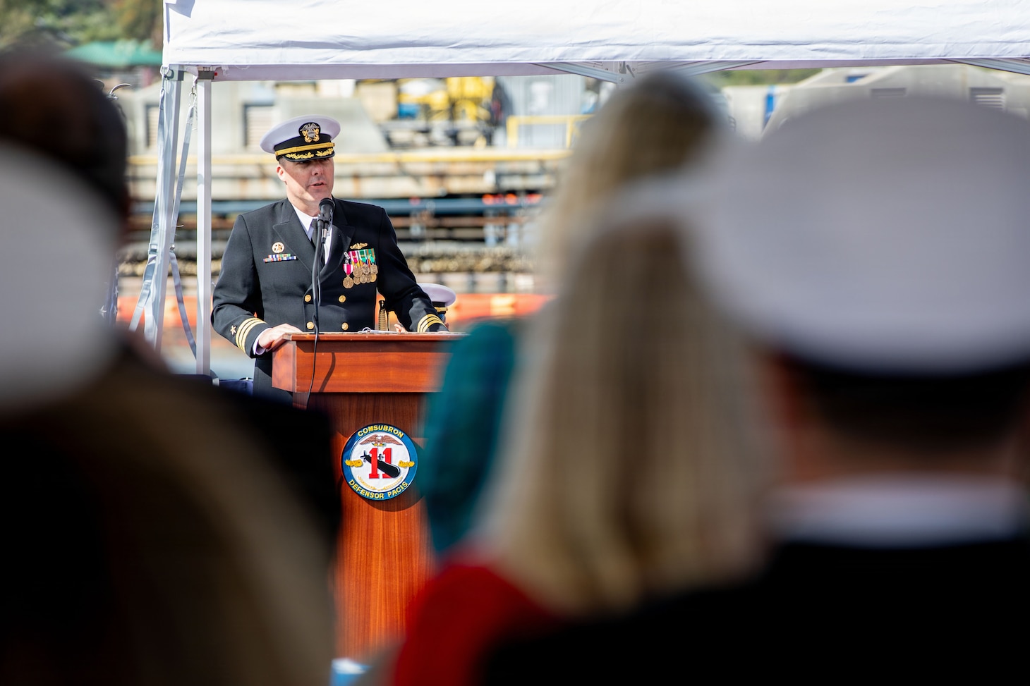 260217-N-DO408-1215 NAVAL BASE POINT LOMA, Calif. (Feb. 17, 2026) Cmdr. Chad Tella, off-going commanding officer, Los Angeles-class fast-attack submarine USS Greeneville (SSN 772), delivers remarks during the change of command ceremony for Greeneville onboard Naval Base Point Loma, Feb. 17, 2026.  During the ceremony, Tella was relieved by Cmdr. Spencer Ovren as commanding officer of Greeneville. Greeneville is assigned to Commander, Submarine Squadron 11, home to four Los Angeles-class fast-attack submarines, which are capable of supporting various missions, including anti-submarine warfare, anti-ship warfare, strike warfare and intelligence, surveillance and reconnaissance. (U.S. Navy photo by Mass Communication Specialist 2nd Class Rashan Jefferson)