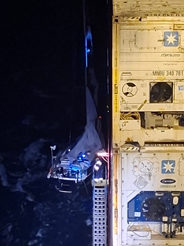 A Coast Guard Air Station Miami HC-144 Ocean Sentry aircrew works alongside the container ship Polar Mexico's crew to rescue a man aboard a disabled 34-foot sailing vessel, 35 miles off Cape Canaveral, Florida, Feb. 22, 2026.