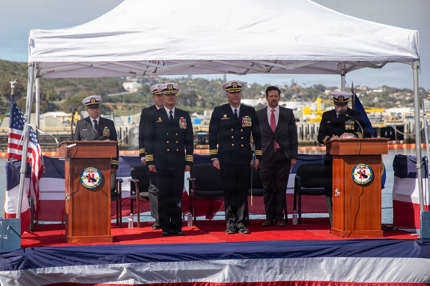 NAVAL BASE POINT LOMA, Calif. (Feb. 17, 2026) Capt. Phillip Sylvia, left, commander, Submarine Squadron 11, stands with Cmdr. Chad Tella, off-going commanding officer, Los Angeles-class fast-attack submarine USS Greeneville (SSN 772), during the change of command ceremony for Greeneville onboard Naval Base Point Loma, Feb. 17, 2026. During the ceremony, Tella was relieved by Cmdr. Spencer Ovren as commanding officer of Greeneville. Greeneville is assigned to Commander, Submarine Squadron 11, home to four Los Angeles-class fast-attack submarines, which are capable of supporting various missions, including anti-submarine warfare, anti-ship warfare, strike warfare and intelligence, surveillance and reconnaissance. (U.S. Navy photo by Mass Communication Specialist 1st Class Tiarra Brown)