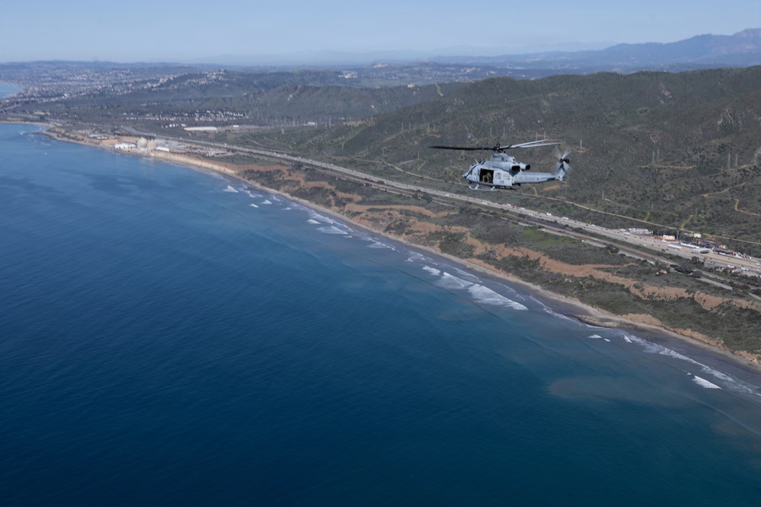 U.S. Marine Corps UH-1Y venom utility helicopter with Marine Light Attack Helicopter Squadron (HMLA) 775, Marine Aircraft Group 41, 4th Marine Aircraft Wing, flies along a coastline at Marine Corps Air Station, Camp Pendleton, California, Jan. 29, 2026. During this period, Marines with HMLA-775 showcased tactical proficiency and lethality of the UH-1Y to the commanding general. (U.S. Marine Corps photo by Lance Cpl. Allan Rodriguez-Rivera)