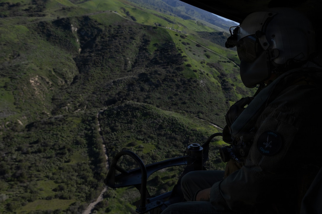 U.S. Marine Corps Sgt. Angel Hernandez, a crew chief with Marine Light Attack Helicopter Squadron (HMLA) 775, Marine Aircraft Group 41, 4th Marine Aircraft Wing, conducts aerial surveillance while in flight at Marine Corps Air Station, Camp Pendleton, California, Jan. 29, 2026. During this period, Marines with HMLA-775 showcased tactical proficiency and lethality of the UH-1Y to the commanding general. (U.S. Marine Corps photo by Lance Cpl. Allan Rodriguez-Rivera)