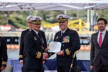 260217-N-DO408-1176 NAVAL BASE POINT LOMA, Calif. (Feb. 17, 2026) Capt. Phillip Sylvia Jr., left, commander, Submarine Squadron 11 (CSS-11), presents a Meritorious Service Medal to Cmdr. Chad Tella, off-going commanding officer, Los Angeles-class fast-attack submarine USS Greeneville (SSN 772), during the change of command ceremony for Greeneville onboard Naval Base Point Loma, Feb. 17, 2026.  During the ceremony, Tella was relieved by Cmdr. Spencer Ovren as commanding officer of Greeneville.  Greeneville is assigned to CSS-11, home to four Los Angeles-class fast-attack submarines, which are capable of supporting various missions, including anti-submarine warfare, anti-ship warfare, strike warfare and intelligence, surveillance and reconnaissance. (U.S. Navy photo by Mass Communication Specialist 2nd Class Rashan Jefferson)