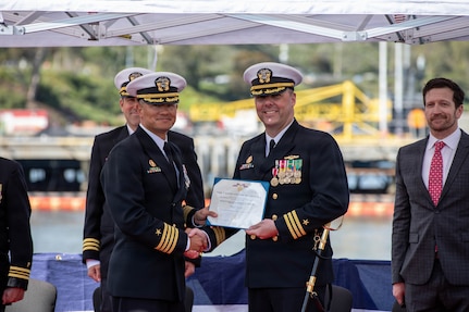 260217-N-DO408-1176 NAVAL BASE POINT LOMA, Calif. (Feb. 17, 2026) Capt. Phillip Sylvia Jr., left, commander, Submarine Squadron 11 (CSS-11), presents a Meritorious Service Medal to Cmdr. Chad Tella, off-going commanding officer, Los Angeles-class fast-attack submarine USS Greeneville (SSN 772), during the change of command ceremony for Greeneville onboard Naval Base Point Loma, Feb. 17, 2026.  During the ceremony, Tella was relieved by Cmdr. Spencer Ovren as commanding officer of Greeneville.  Greeneville is assigned to CSS-11, home to four Los Angeles-class fast-attack submarines, which are capable of supporting various missions, including anti-submarine warfare, anti-ship warfare, strike warfare and intelligence, surveillance and reconnaissance. (U.S. Navy photo by Mass Communication Specialist 2nd Class Rashan Jefferson)