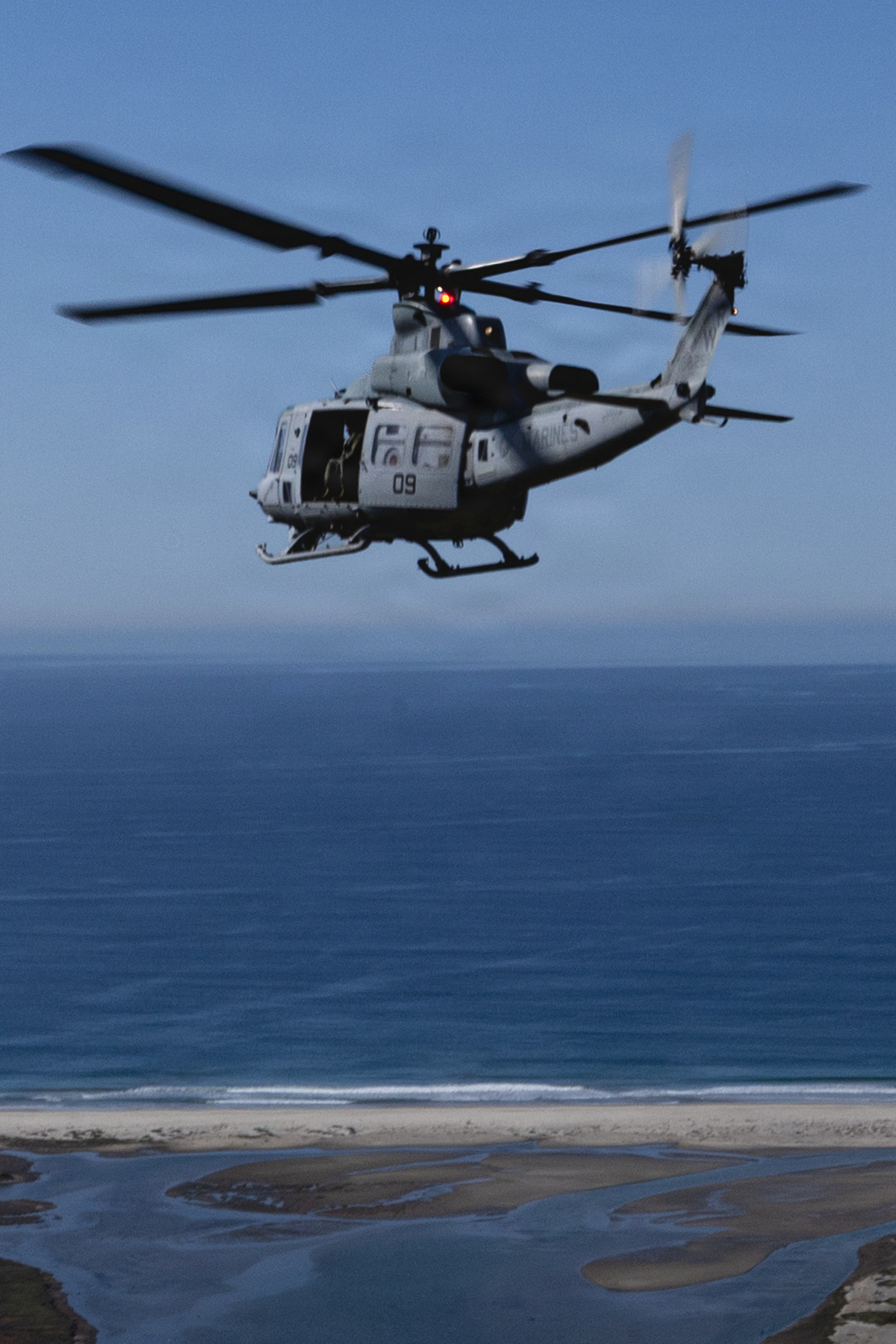 U.S. Marines with Marine Light Attack Helicopter Squadron (HMLA) 775, Marine Aircraft Group 41, 4th Marine Aircraft Wing, operate in a UH-1Y Venom utility helicopter along a coastline at Marine Corps Air Station, Camp Pendleton, California, Jan. 29, 2026. During this period, Marines with HMLA-775 showcased tactical proficiency and lethality of the UH-1Y to the commanding general. (U.S. Marine Corps photo by Lance Cpl. Allan Rodriguez-Rivera)