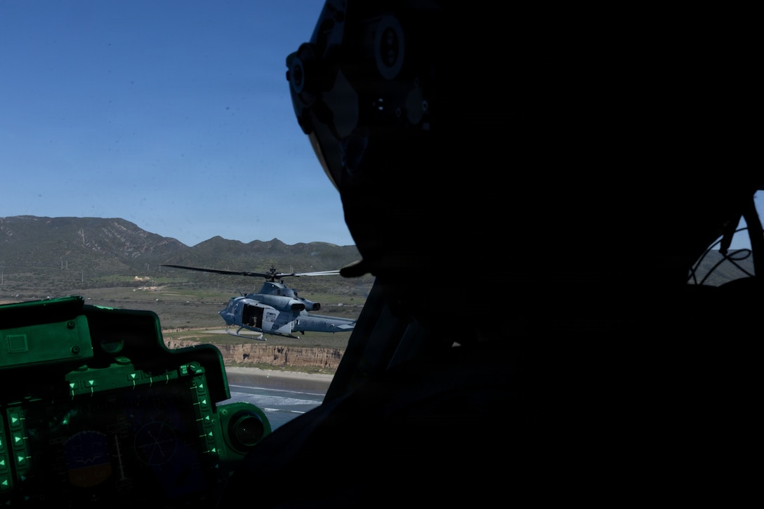 A U.S. Marine flies in formation with another UH-1Y Venom utility helicopter with Marine Light Attack Helicopter Squadron (HMLA) 775, Marine Aircraft Group 41, 4th Marine Aircraft Wing, at Marine Corps Air Station, Camp Pendleton, California, Jan. 29, 2026. During this period, Marines with HMLA-775 showcased tactical proficiency and lethality of the UH-1Y to the commanding general. (U.S. Marine Corps photo by Lance Cpl. Allan Rodriguez-Rivera)