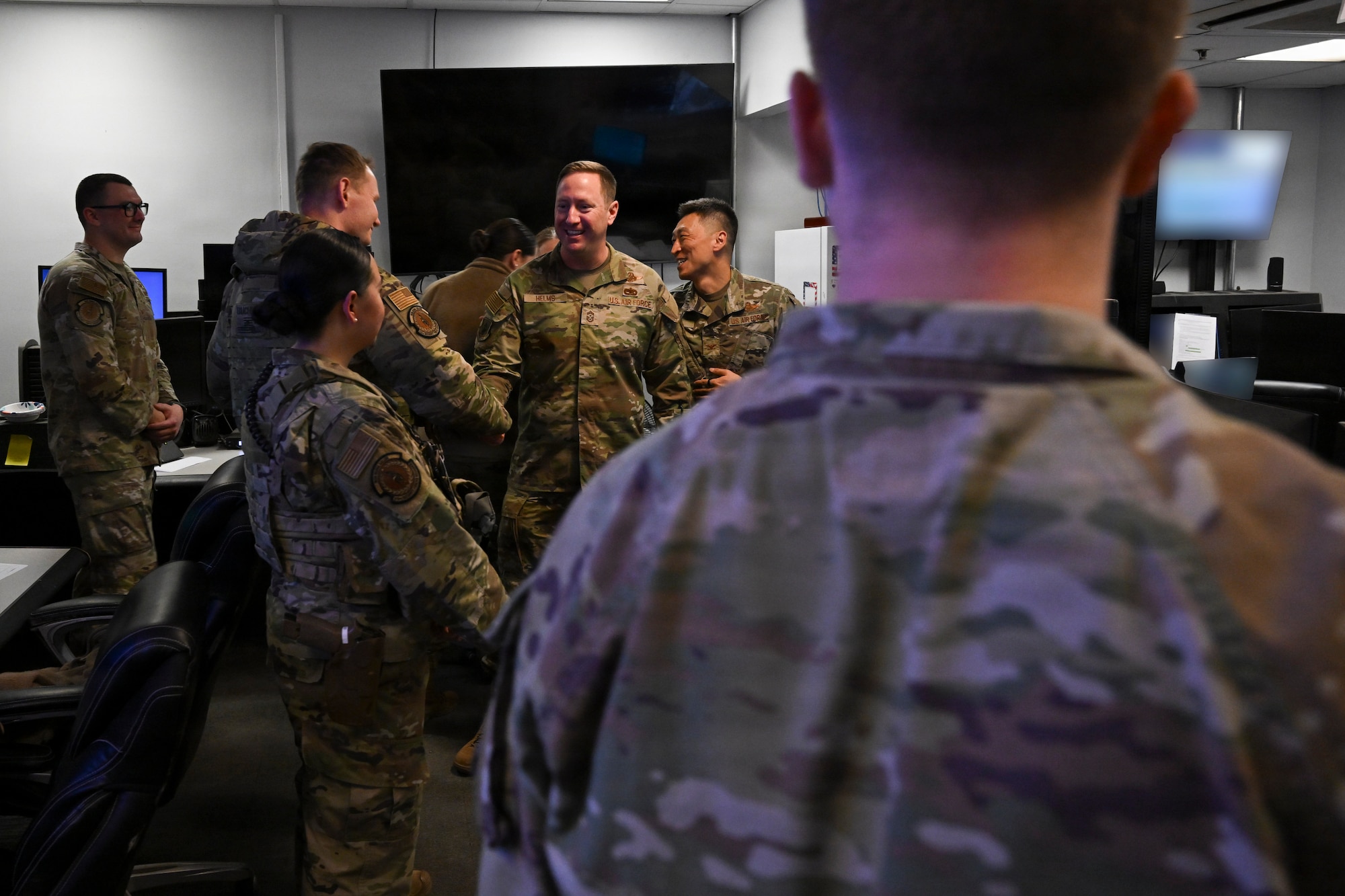 U.S. Air Force base leadership shakes hands with 316th Security Forces Squadron Base Defense Operations Center controllers in conclusion of the February “Winnin’ Like a Griffin” recognition at Joint Base Andrews, Maryland, Feb. 17, 2026. The visit highlighted outstanding performance across the installation.