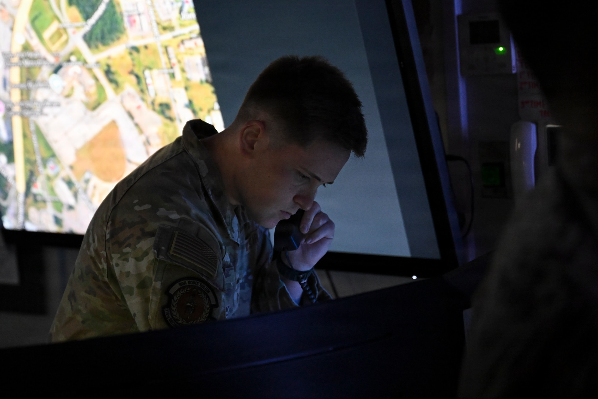 U.S. Air Force Staff Sgt. Joel A. Ezzi, 316th Security Forces Squadron Base Defense Operations Center controller, responds to an incoming call during the February “Winnin’ Like a Griffin” recognition at Joint Base Andrews, Maryland, Feb. 17, 2026. Ezzi was coined by the base commander for outstanding performance and leadership.