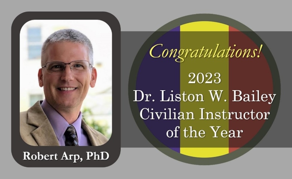 Graphic congratulating Dr. Robert Arp as the 2023 Dr. Liston W. Bailey Civilian Instructor of the Year, with his portrait and award text.