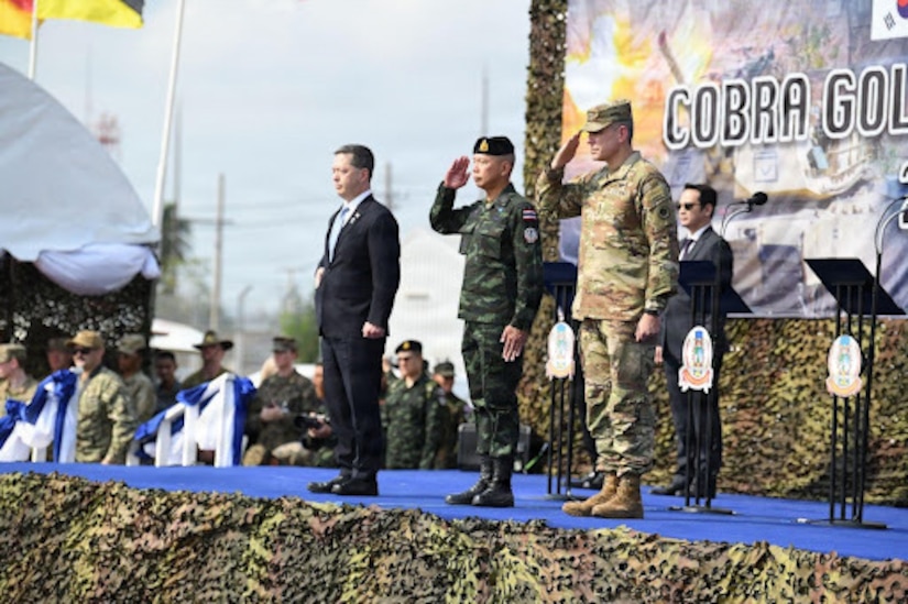 Sean K. O'Neill, U.S. Ambassador to Thailand, Gen. Ukris Boontanondha, Chief of Defense Forces Thailand, and U.S. Army Lt. Gen. Matthew W. McFarlane, the Commanding General of America’s First Corps and Joint Base Lewis-McChord, Wash., render a salute at the opening ceremony of Exercise Cobra Gold in Rayong Province, Thailand, Feb. 24, 2026.