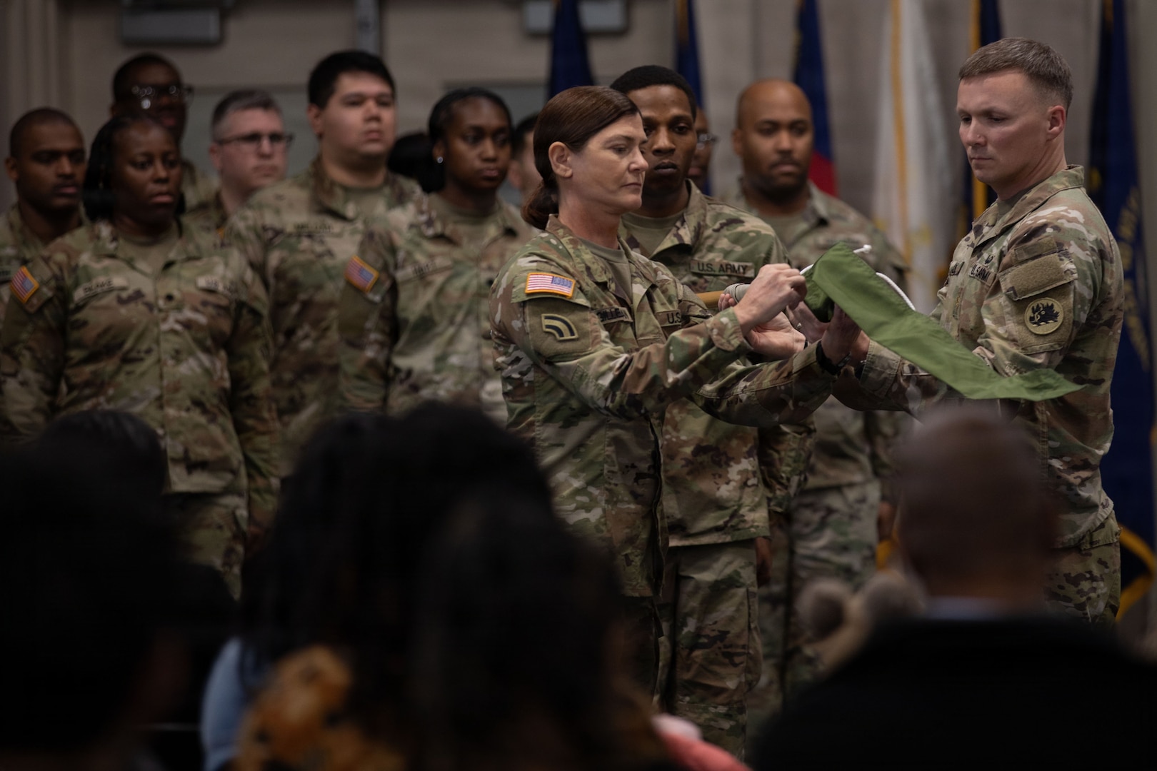 U.S. Army Command Sgt. Maj. Kimberly Gilleran and Maj. Nicholas Long, senior enlisted leader and commander of the Marietta-based 93rd Financial Management Support Detachment, 781st Troop Command Detachment, 78th Troop Command, Georgia Army National Guard, case the battalion's colors during the unit's departure ceremony at Clay National Guard Center, Marietta, Georgia, Feb. 7, 2026. The ceremony was held in honor of the unit's upcoming mobilization to the U.S. Army Central Command's area of responsibility. The mission of the unit is to provide financial support to units from brigade to theater level. The casing of the colors symbolizes the unit's readiness and preparation to operate away from their home station. (U.S. Army National Guard photo by Spc. Ayanna Tillman)