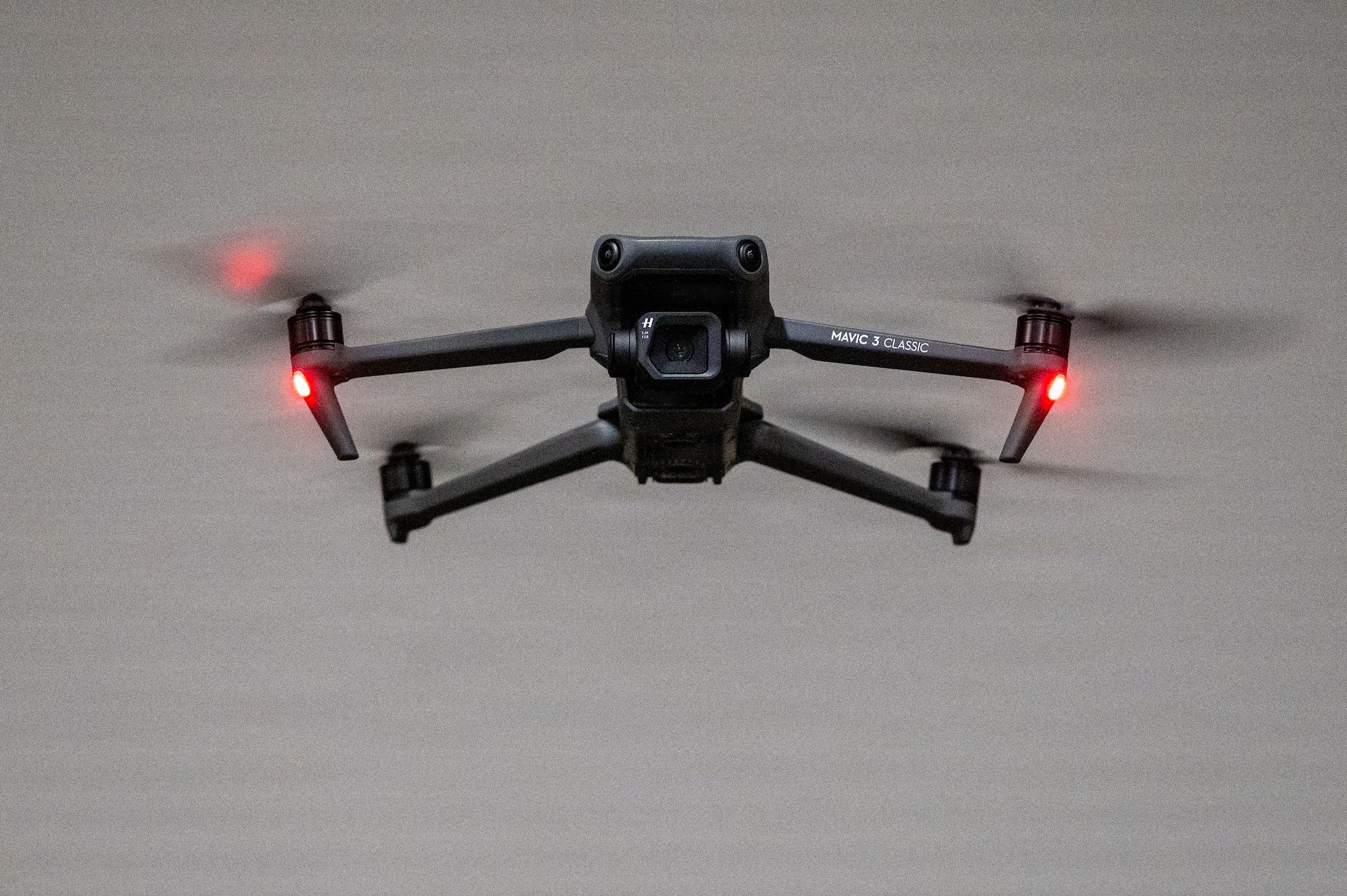 A black drone hovers in the air for the photo.