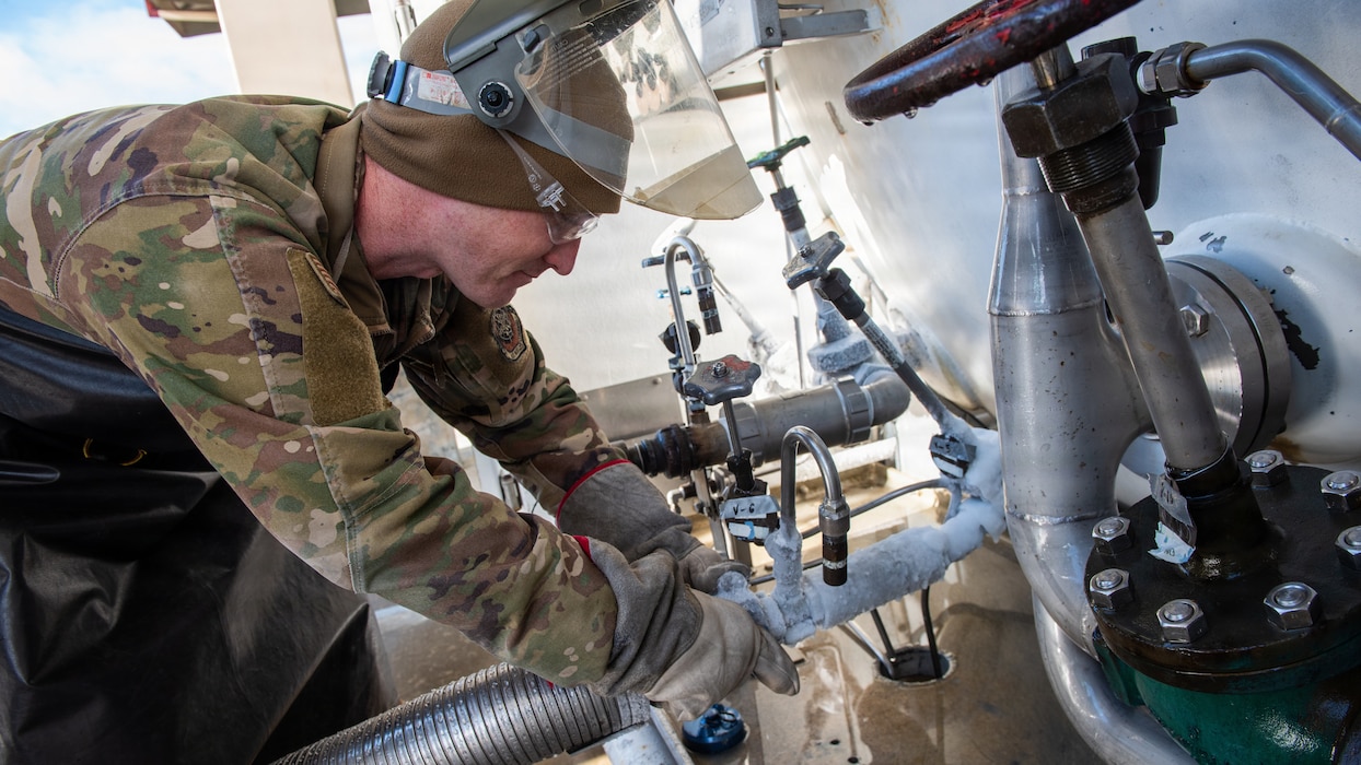 Airman adjusts valves on servicing system